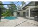 Screened-in pool area with a pool and a tiled patio at 8518 Quail Hollow Blvd, Wesley Chapel, FL 33544