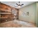 Spacious room featuring unique wood wall design and tiled floors at 8518 Quail Hollow Blvd, Wesley Chapel, FL 33544