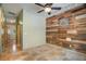 Spacious room featuring unique wood wall design and tiled floors at 8518 Quail Hollow Blvd, Wesley Chapel, FL 33544