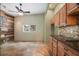 Spacious room featuring custom wood cabinetry, tiled floors, and unique wood wall at 8518 Quail Hollow Blvd, Wesley Chapel, FL 33544