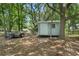 Backyard storage shed with trailer and mature trees for shade at 8518 Quail Hollow Blvd, Wesley Chapel, FL 33544