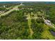 Aerial shot of a spacious property with scattered homes, lush greenery, and a visible water feature at 8540 Roseanne Blvd, New Port Richey, FL 34654
