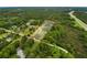 Aerial image of a property marked by a border, amidst dense trees, greenery, nearby roads, and local residences at 8540 Roseanne Blvd, New Port Richey, FL 34654