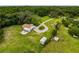 Aerial view of a home with a circular driveway, mature trees, and lots of land at 8540 Roseanne Blvd, New Port Richey, FL 34654
