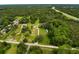 Aerial view of a home and its expansive, tree-filled property next to a highway at 8540 Roseanne Blvd, New Port Richey, FL 34654