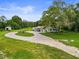 Wide aerial shot featuring house with circular driveway and mature trees at 8540 Roseanne Blvd, New Port Richey, FL 34654