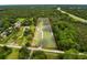 Aerial view of a home and its expansive, tree-filled property, the borders outlined in red at 8540 Roseanne Blvd, New Port Richey, FL 34654