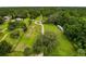 Sprawling property showcasing a residence, outbuilding, circular driveway, mature trees, and serene surroundings at 8540 Roseanne Blvd, New Port Richey, FL 34654