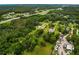 Scenic aerial view of sprawling land with lush greenery, complemented by nearby roads and a pond at 8540 Roseanne Blvd, New Port Richey, FL 34654
