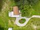 Overhead shot showcasing the home's layout, driveway, and surrounding greenery at 8540 Roseanne Blvd, New Port Richey, FL 34654