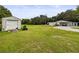 Exterior view of home with a shed and a vast backyard at 8540 Roseanne Blvd, New Port Richey, FL 34654