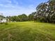 Expansive backyard showcases a large open grassy area, ideal for outdoor activities at 8540 Roseanne Blvd, New Port Richey, FL 34654