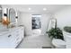 Bright bathroom boasts a double vanity with marble countertop, modern fixtures, and neutral-toned tile floors at 8540 Roseanne Blvd, New Port Richey, FL 34654