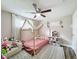 Charming bedroom with a bed frame draped in sheer white fabric, plush rugs, and bright lighting at 8540 Roseanne Blvd, New Port Richey, FL 34654