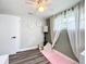 Bright bedroom featuring modern ceiling fan, bright natural light and daisy wall decorations at 8540 Roseanne Blvd, New Port Richey, FL 34654