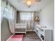 Bright Bedroom with a white crib, modern ceiling fan and bright natural light at 8540 Roseanne Blvd, New Port Richey, FL 34654