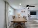 Bright dining room with wood dining table and ceiling fan at 8540 Roseanne Blvd, New Port Richey, FL 34654