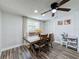 Bright dining room featuring a wood dining table, wood-look flooring and a ceiling fan at 8540 Roseanne Blvd, New Port Richey, FL 34654