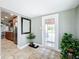 Bright entryway featuring tile flooring, a decorative mirror, and a glass-paned door leading to outdoor views at 8540 Roseanne Blvd, New Port Richey, FL 34654