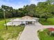 Aerial view of property, showcasing the back of the home, covered patio, and winding driveway at 8540 Roseanne Blvd, New Port Richey, FL 34654