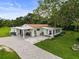 Charming single-story home with a well-manicured lawn and a paved driveway under a sunny sky at 8540 Roseanne Blvd, New Port Richey, FL 34654