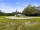 Charming one story home featuring a circular driveway, lush landscaping, and a welcoming front porch at 8540 Roseanne Blvd, New Port Richey, FL 34654