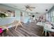 Spacious living room featuring a neutral palette, wooden floors and modern ceiling fans at 8540 Roseanne Blvd, New Port Richey, FL 34654