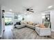 Bright living room showcases a comfortable sectional sofa and large windows at 8540 Roseanne Blvd, New Port Richey, FL 34654