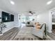 Comfortable living room features new floors, plush rug, modern lighting, and neutral decor at 8540 Roseanne Blvd, New Port Richey, FL 34654
