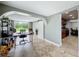 Bright living space with a desk, arched entryway, barn door, tile flooring, and access to outdoor views at 8540 Roseanne Blvd, New Port Richey, FL 34654