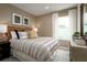 Cozy bedroom with stylish decor, comfortable bed, and natural light from the window complete with carpet flooring at 8921 Waxwing Way, Parrish, FL 34219