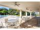 Relaxing pool area with tables, lounge chairs and ceiling fans for outdoor comfort and shade at 8921 Waxwing Way, Parrish, FL 34219