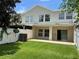 A two-story home showing the backyard with a white fence and grass at 930 Woodbridge Ct, Safety Harbor, FL 34695