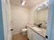 Powder room featuring a granite countertop, under mount sink, and tile flooring at 930 Woodbridge Ct, Safety Harbor, FL 34695