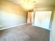 Cozy bedroom with neutral carpeting, a double door closet, and ample space for furniture at 930 Woodbridge Ct, Safety Harbor, FL 34695