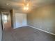 Comfortable bedroom featuring neutral carpeting, a ceiling fan, and a large closet at 930 Woodbridge Ct, Safety Harbor, FL 34695