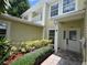 Charming two-story home featuring well-maintained landscaping, a welcoming front entrance, and a private balcony at 930 Woodbridge Ct, Safety Harbor, FL 34695