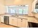 Kitchen featuring stainless steel appliances, a breakfast bar, granite countertops, and white cabinetry at 930 Woodbridge Ct, Safety Harbor, FL 34695