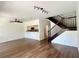 Open concept living room with wood floors and stairs to the second floor at 930 Woodbridge Ct, Safety Harbor, FL 34695