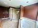 Elegant bathroom featuring walk-in shower, jacuzzi tub and neutral tile at 930 Woodbridge Ct, Safety Harbor, FL 34695