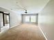 Spacious main bedroom with natural light, carpet flooring and ensuite bathroom entrance at 930 Woodbridge Ct, Safety Harbor, FL 34695