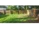 A backyard area with some grass and a wooden fence at 9432 84Th St, Seminole, FL 33777