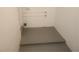 Unfinished basement area with concrete floor, a door, and visible piping, perfect for storage or future customization at 9432 84Th St, Seminole, FL 33777