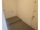 Unfinished basement area with concrete floor, a door, and visible piping, perfect for storage or future customization at 9432 84Th St, Seminole, FL 33777