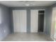 Comfortable bedroom featuring tile flooring, neutral paint and sliding door closets at 9432 84Th St, Seminole, FL 33777