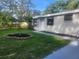Single-story home with a tidy lawn, featuring a decorative tree and painted driveway at 9432 84Th St, Seminole, FL 33777