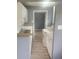 Efficient kitchen featuring white cabinets, neutral countertops and flooring with an open doorway to another room at 9432 84Th St, Seminole, FL 33777