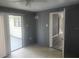 Bright living room featuring vinyl floors, neutral paint, and sliding glass door access to outside at 9432 84Th St, Seminole, FL 33777