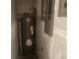 Utility room featuring a water heater and electrical panel, highlighting essential home systems for maintenance at 9432 84Th St, Seminole, FL 33777