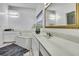 Bright bathroom featuring dual sinks, a bathtub, and decorative gold-framed mirror at 10093 Holly Berry Dr, Weeki Wachee, FL 34613